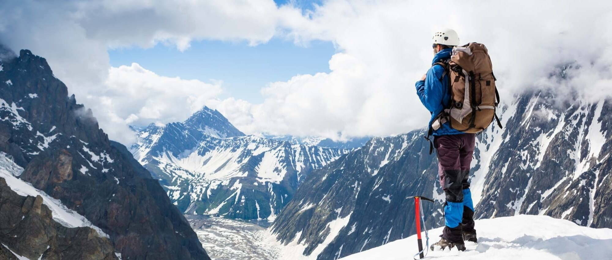 Man climbing to the peak of the mountain