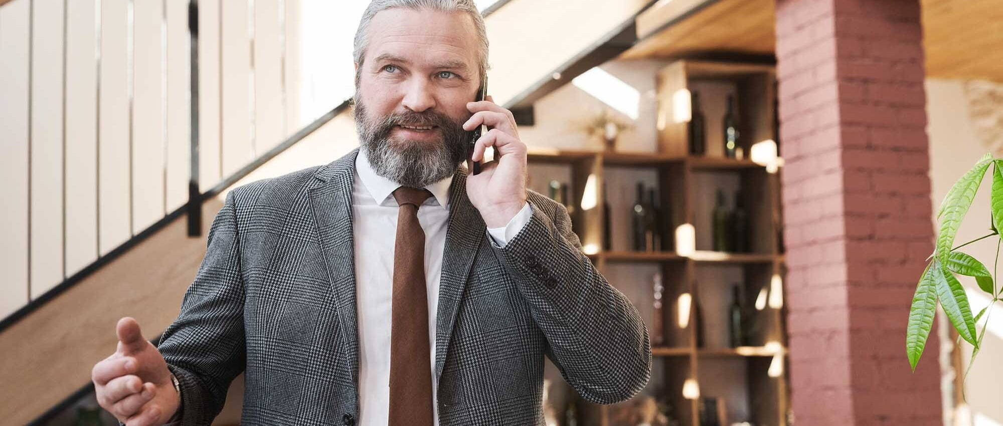 Mature man using his smartphone to make a call